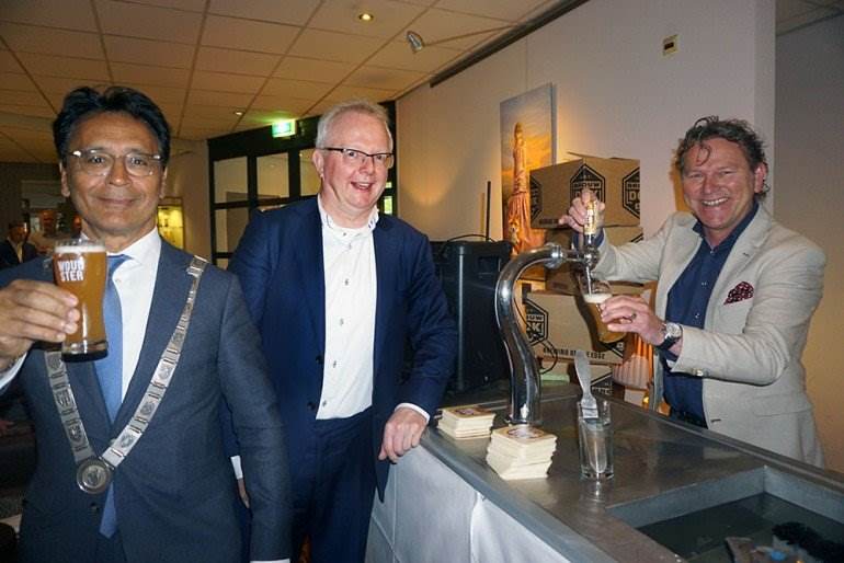 Proosten op Woudster. Burgemeester Tjeerd van der Zwan van Heerenveen proefde het eerste bier, getapt door Reitse Spanninga. Directeur Tjitte de Wolff van Tjaarda kijkt toe.